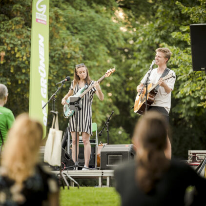 Zwei Musiker:innen auf der Bühne bei Musik am Fluss